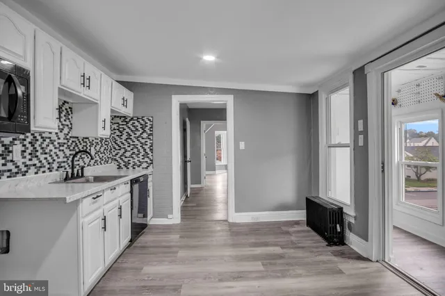 a kitchen with granite countertop a sink and cabinets