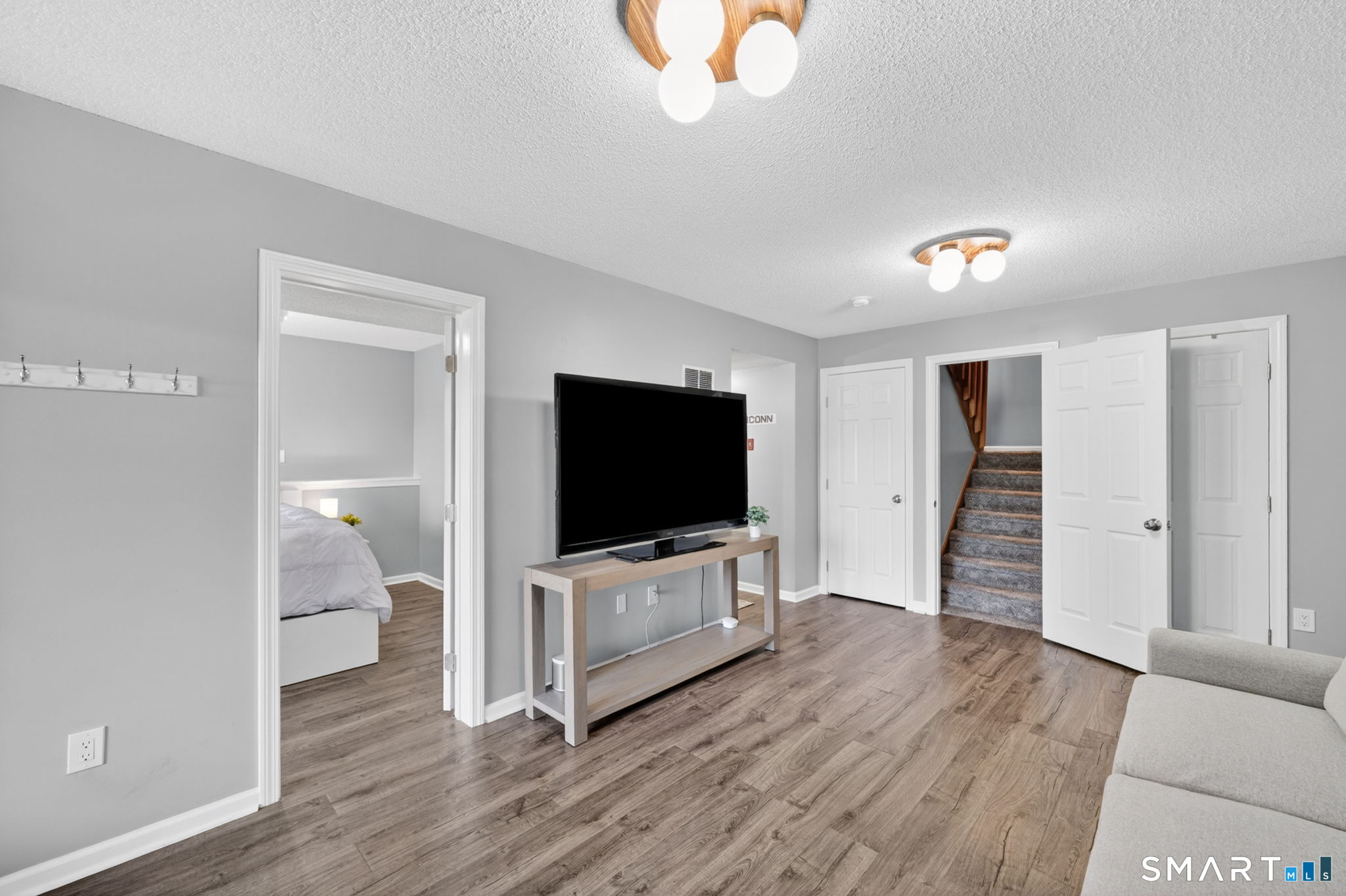 10 Depot Road, Unit 22 Willington, CT 06279 - Photo 22 of 36 a living room with hardwood floor and flat screen tv