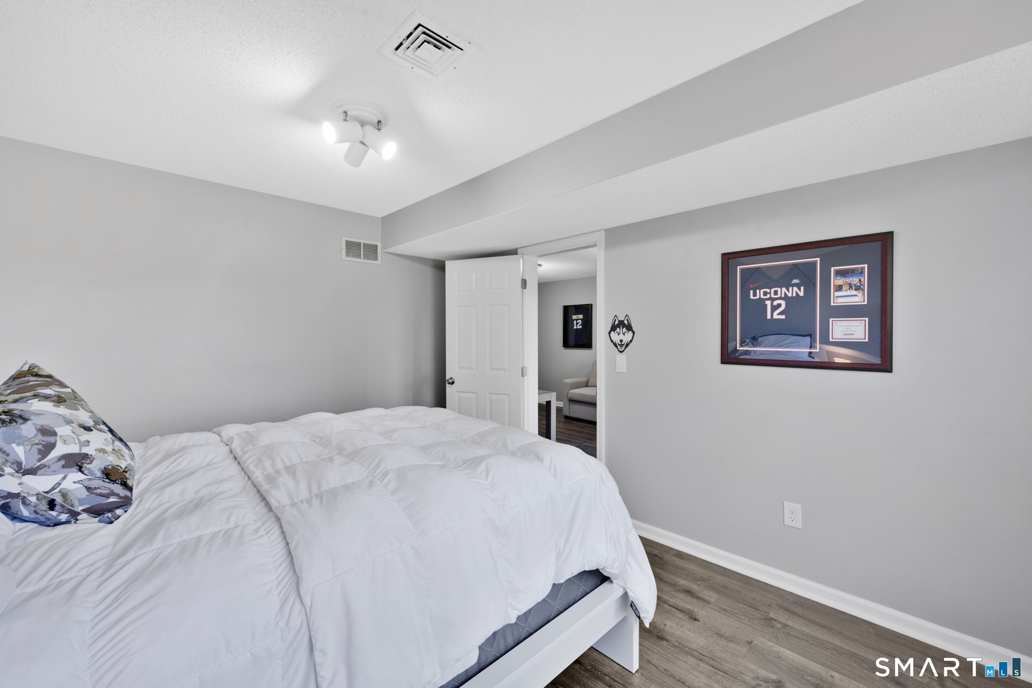 10 Depot Road, Unit 22 Willington, CT 06279 - Photo 24 of 36 a bedroom with a large bed and a chandelier