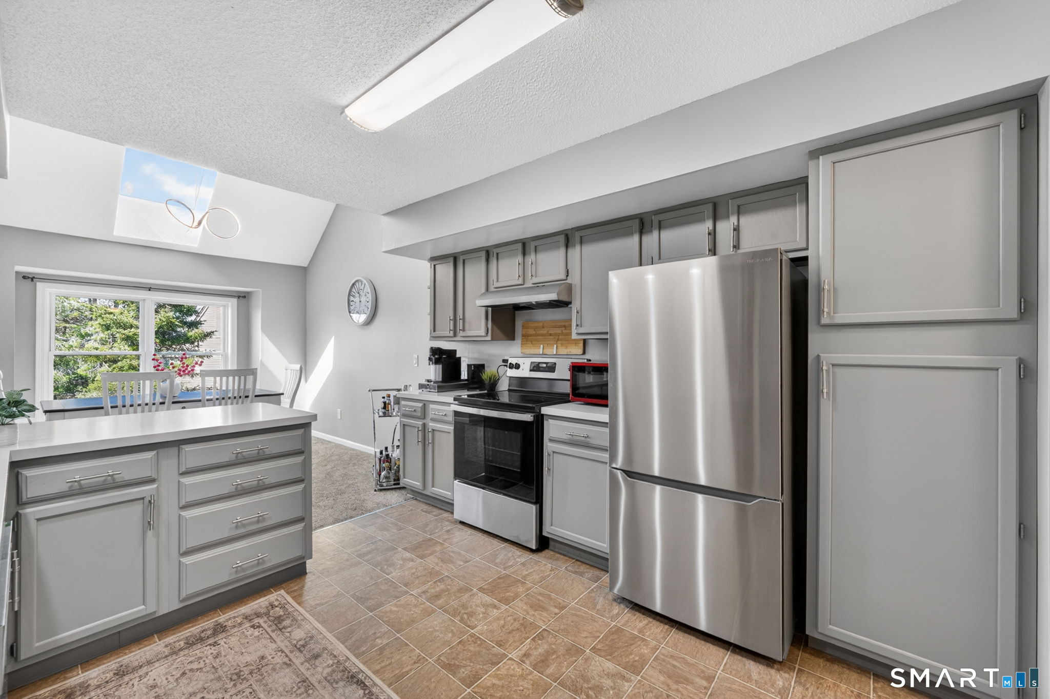 10 Depot Road, Unit 22 Willington, CT 06279 - Photo 10 of 36 a kitchen with stainless steel appliances a refrigerator sink and cabinets
