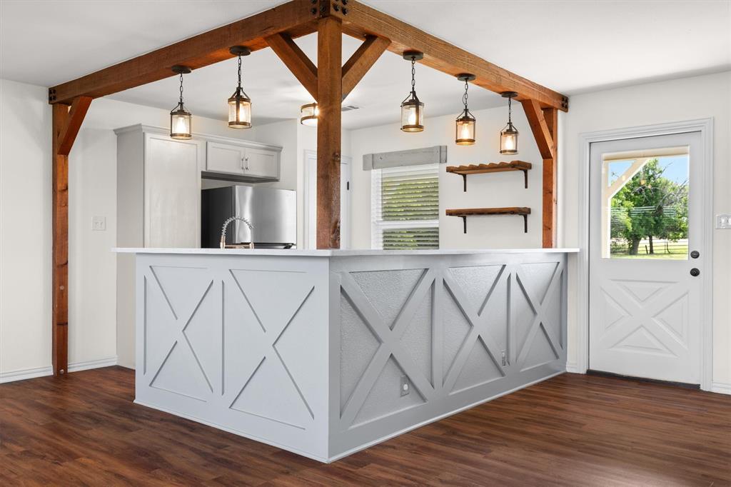 13132 Highway 78 Blue Ridge, TX 75424 - Photo 6 of 35 Kitchen island featuring X-pattern paneling and a light-toned countertop