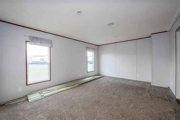 a view of an empty room with windows