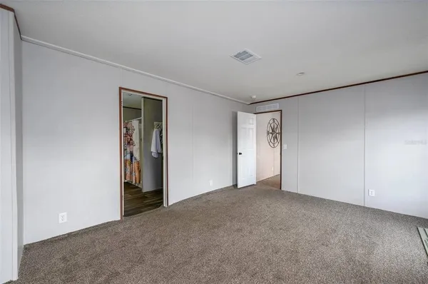 a view of an empty room and closet area
