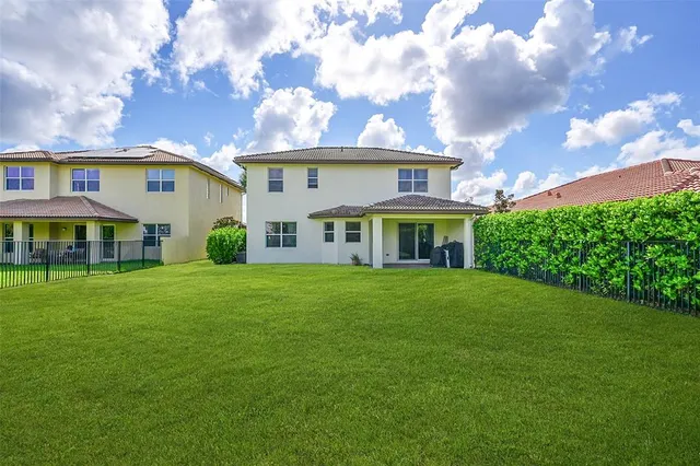 a view of a dining room with furniture a chandelier and wooden floor