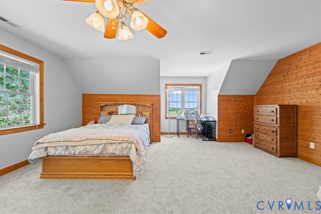 3137 Trenholm Road Powhatan, VA 23139 - Photo 35 of 72 a bedroom with a bed and a chandelier