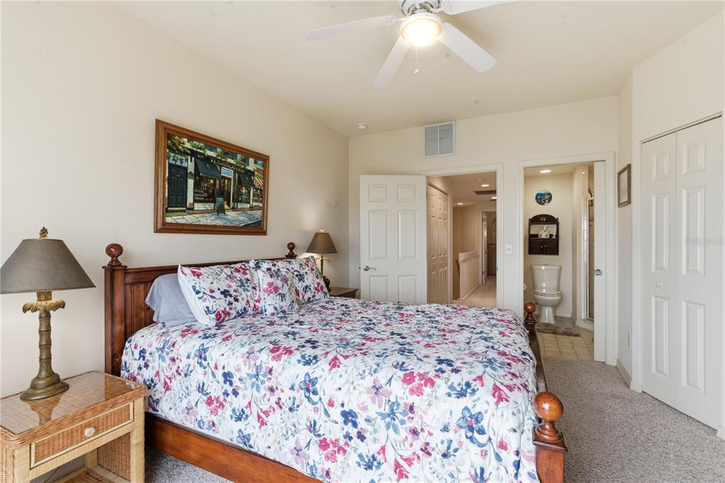 1246 Rio De Janeiro Avenue, Unit 503 Punta Gorda, FL 33983 - Photo 15 of 34 a bedroom with a large bed and a chandelier
