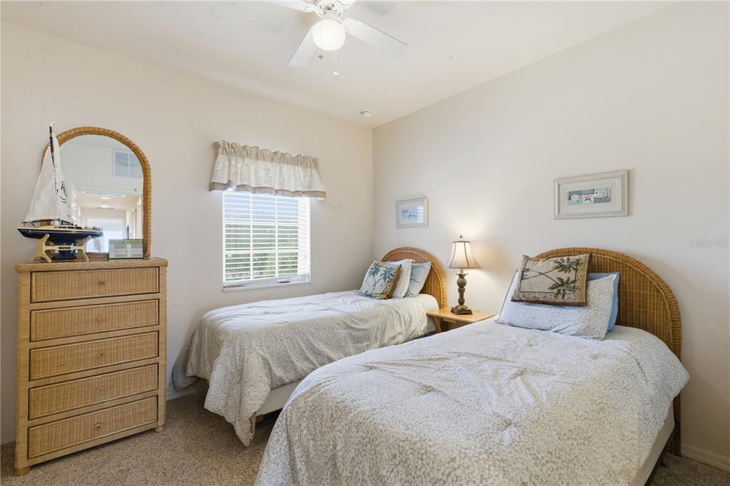 1246 Rio De Janeiro Avenue, Unit 503 Punta Gorda, FL 33983 - Photo 18 of 34 a bedroom with two beds and a dresser