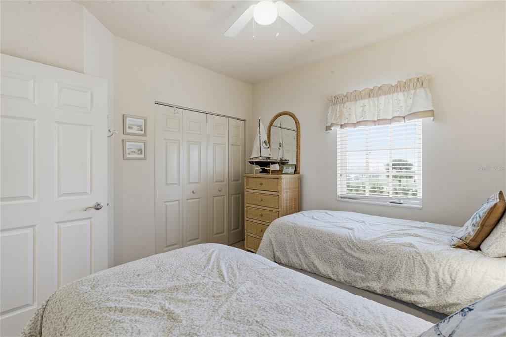 1246 Rio De Janeiro Avenue, Unit 503 Punta Gorda, FL 33983 - Photo 19 of 34 a bedroom with a bed and a dresser