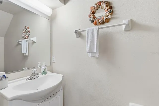 a bathroom with a sink and mirror