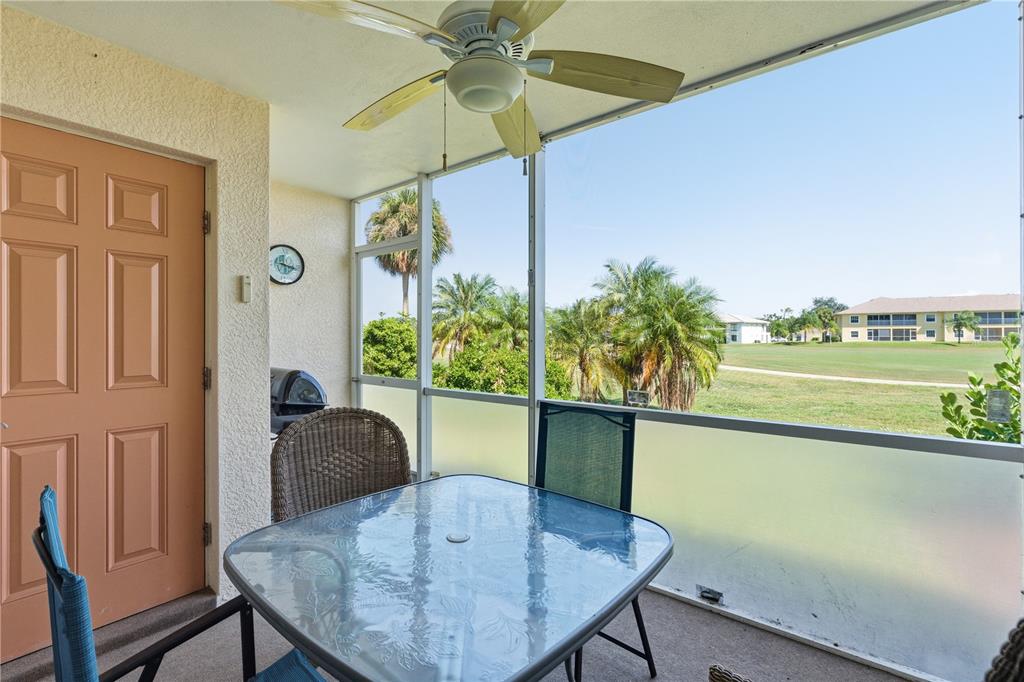 1246 Rio De Janeiro Avenue, Unit 503 Punta Gorda, FL 33983 - Photo 22 of 34 a view of a dining room with furniture and a floor to ceiling window