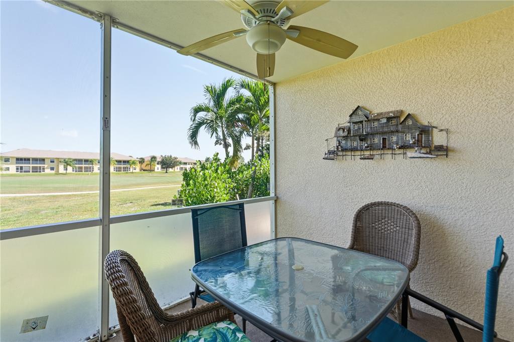 1246 Rio De Janeiro Avenue, Unit 503 Punta Gorda, FL 33983 - Photo 23 of 34 a table with a potted plant and a chair