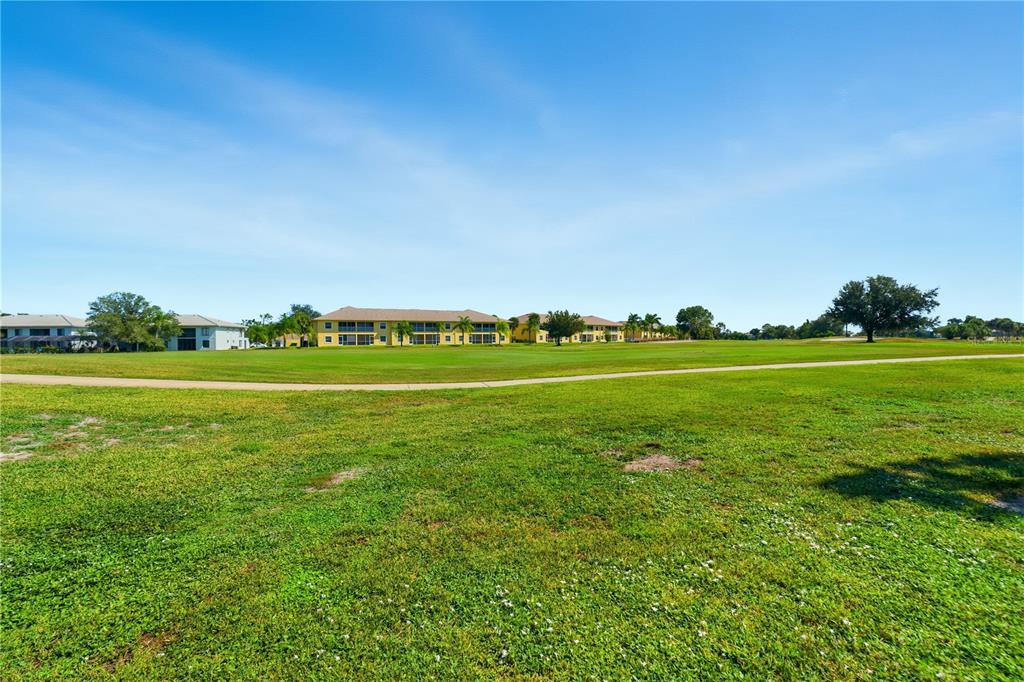 1246 Rio De Janeiro Avenue, Unit 503 Punta Gorda, FL 33983 - Photo 25 of 34 a view of a golf course with a lake
