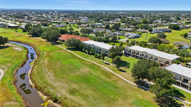 an aerial view of residential houses with outdoor space and swimming pool