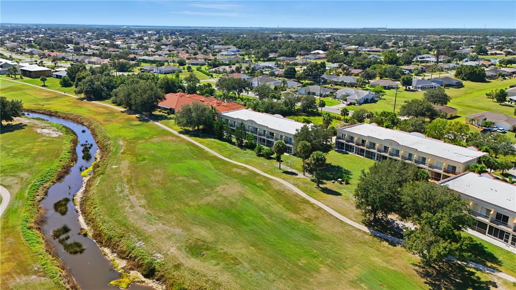 1246 Rio De Janeiro Avenue, Unit 503 Punta Gorda, FL 33983 - Photo 30 of 34 an aerial view of residential houses with outdoor space and swimming pool