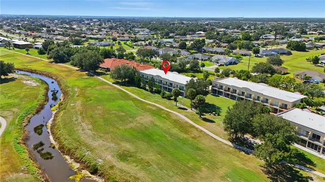 an aerial view of residential houses with outdoor space and swimming pool