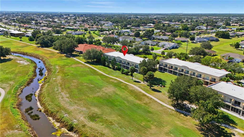 1246 Rio De Janeiro Avenue, Unit 503 Punta Gorda, FL 33983 - Photo 31 of 34 an aerial view of residential houses with outdoor space and swimming pool