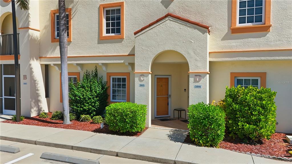 1246 Rio De Janeiro Avenue, Unit 503 Punta Gorda, FL 33983 - Photo 32 of 34 a front view of a house with plants