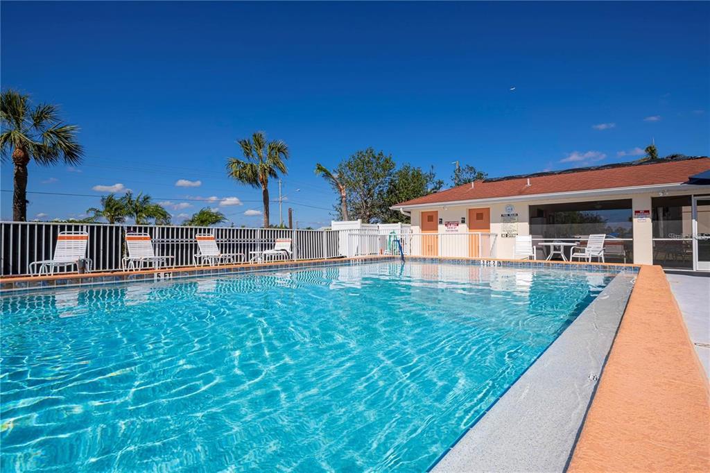 1246 Rio De Janeiro Avenue, Unit 503 Punta Gorda, FL 33983 - Photo 33 of 34 swimming pool view with a seating space and garden view