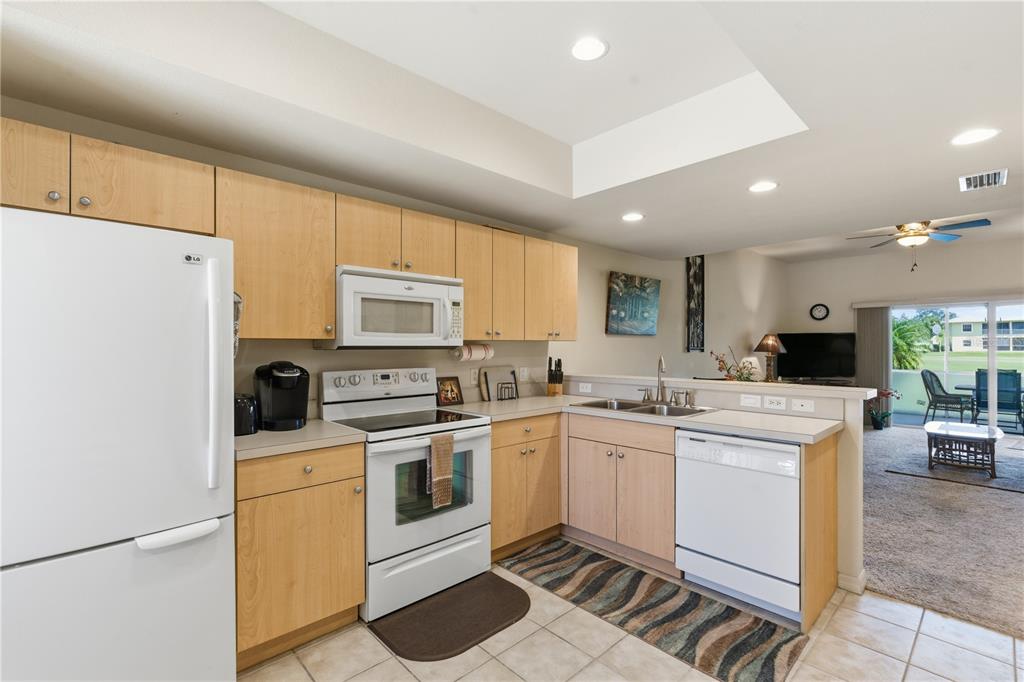1246 Rio De Janeiro Avenue, Unit 503 Punta Gorda, FL 33983 - Photo 6 of 34 a kitchen with a sink a stove and refrigerator
