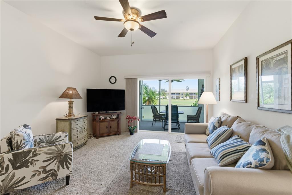 1246 Rio De Janeiro Avenue, Unit 503 Punta Gorda, FL 33983 - Photo 10 of 34 a living room with furniture and a flat screen tv