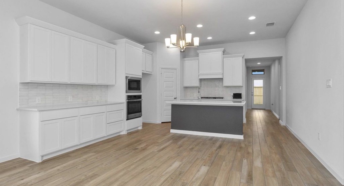 303 Eileen Drive Rosenberg, TX 77471 - Photo 2 of 17 a large kitchen with kitchen island a sink stainless steel appliances and cabinets