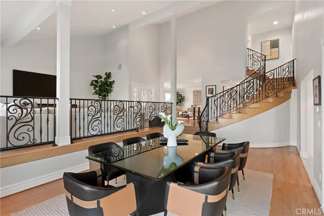 a kitchen with stainless steel appliances kitchen island granite countertop a stove a sink a refrigerator and a dining table with the kitchen view