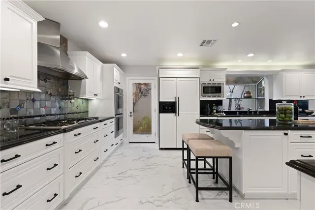 a bathroom with a granite countertop sink a mirror a shower and a bathtub