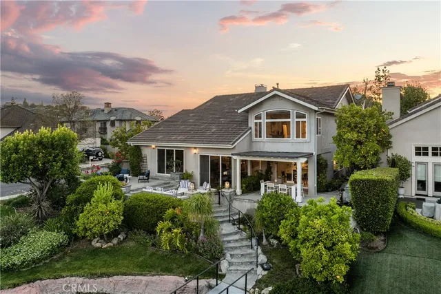 an aerial view of multiple houses with a city street