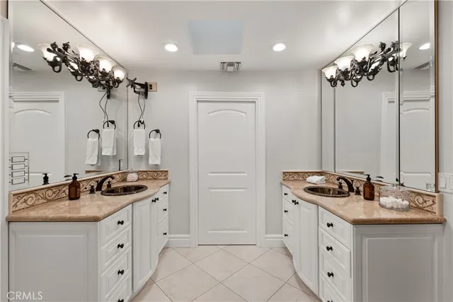 a view of a house with a yard and potted plants