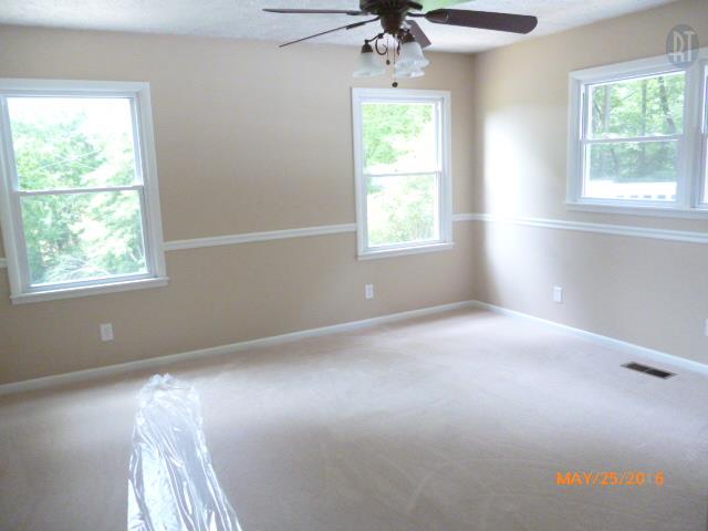 450 West Piney Road Dickson, TN 37055 - Photo 12 of 29 en empty room with windows and chandelier fan