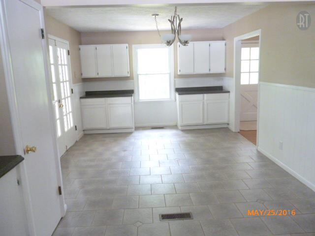 450 West Piney Road Dickson, TN 37055 - Photo 15 of 29 a kitchen with granite countertop white cabinets and window