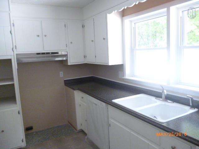 450 West Piney Road Dickson, TN 37055 - Photo 16 of 29 a kitchen with granite countertop white cabinets and a sink