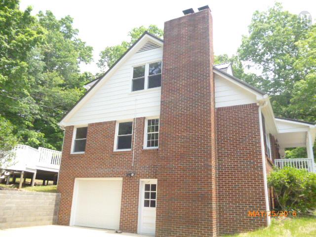 450 West Piney Road Dickson, TN 37055 - Photo 3 of 29 a backyard of a house with plants and outdoor seating