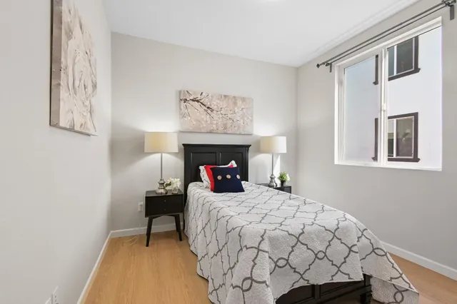 a bedroom with a bed and a window