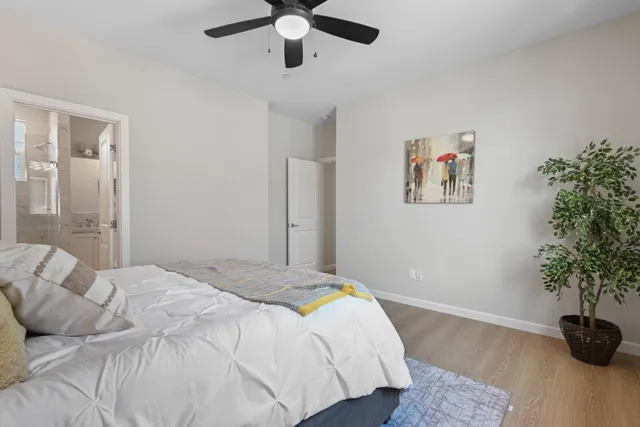 a bedroom with a bed and a potted plant
