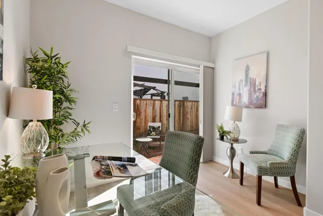 a living room with furniture and a potted plant