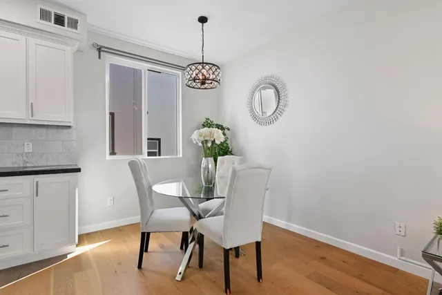 a view of a dining room with furniture wooden floor and chandelier