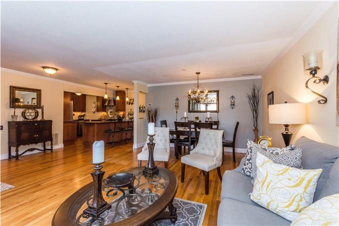 a living room with furniture kitchen view and a table