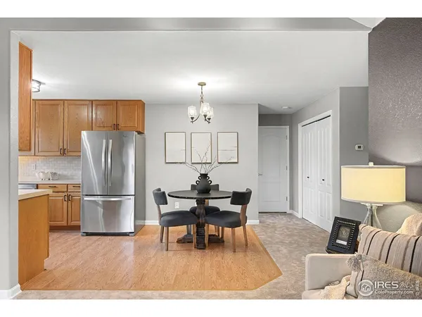 a living room with furniture and a dining table with kitchen view