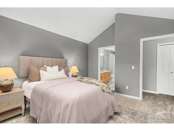 a bedroom with a bed and mirror