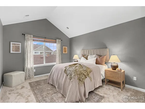 a bed room with a bed and a large window