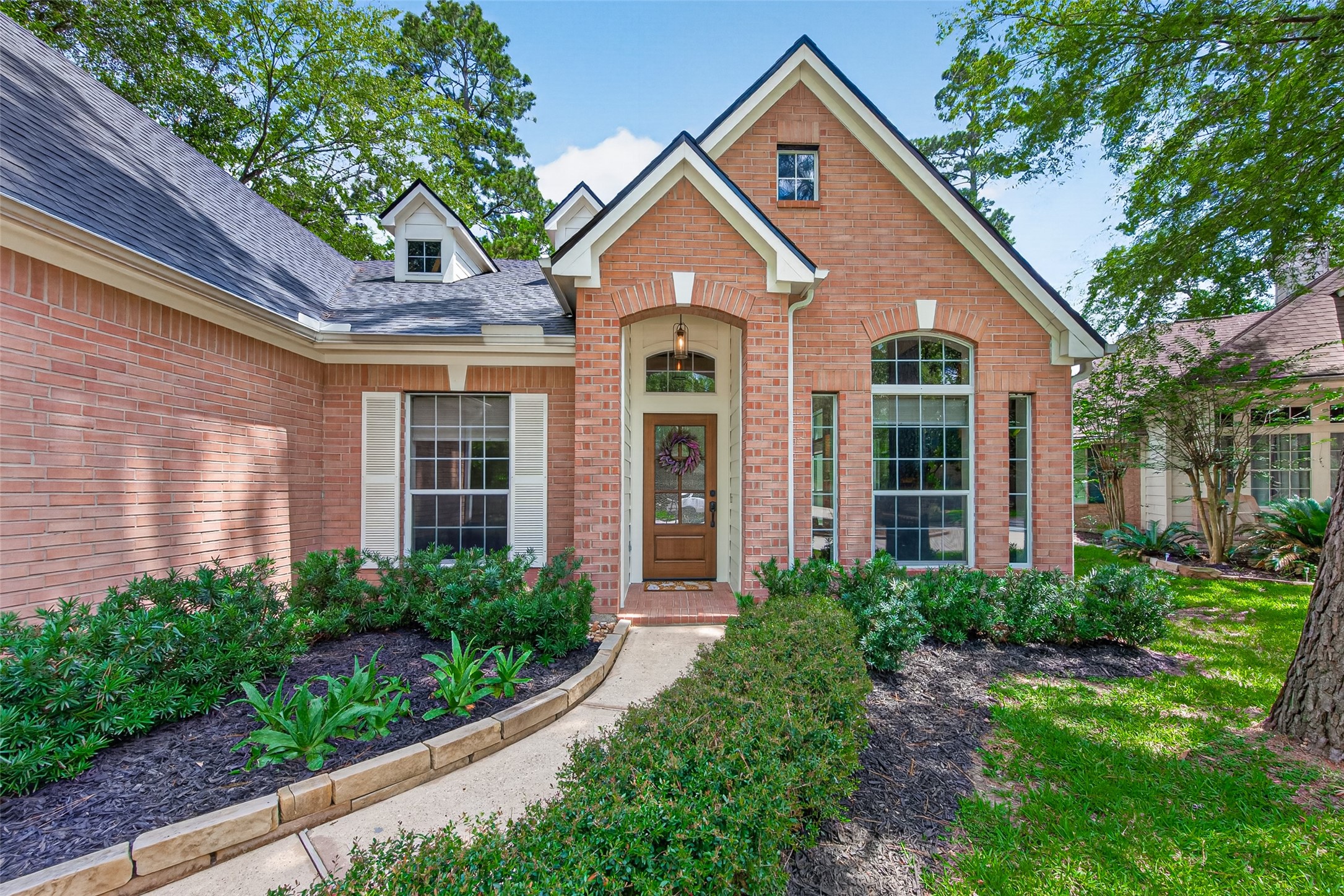 10 Belcarra Place Spring, TX 77382 - Photo 3 of 49 The front and rear landscaping have been designed and allowed to mature beautifully! Lovely curved walk way to the entry flanked by lush plants.