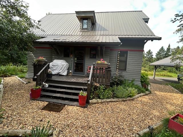89095 Aster Road Cornucopia, WI 54827 - Photo 2 of 37 Rear view of property featuring a metal roof and a wooden deck