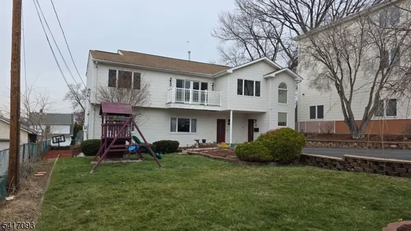 a view of a house with a yard and sitting area
