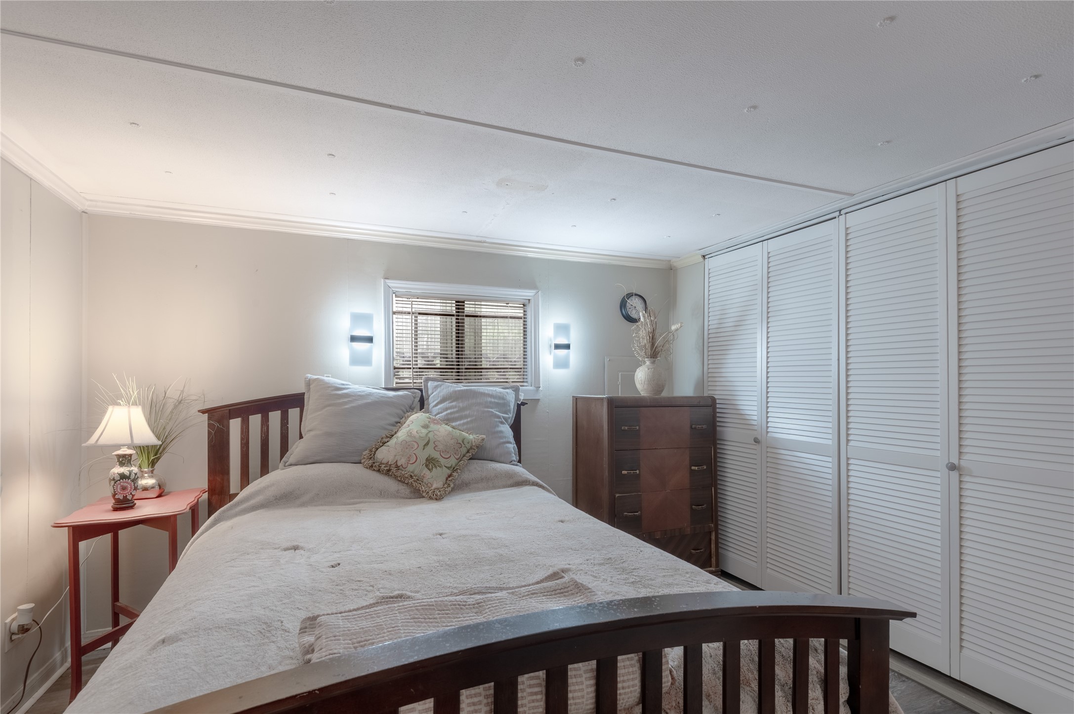 159 Pecan Avenue Groveton, TX 75845 - Photo 10 of 27 a bedroom with a bed and wooden floor