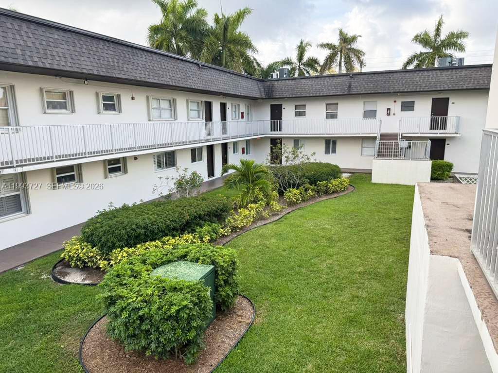 8475 Southwest 94th Street, Unit 119E Miami, FL 33156 - Photo 14 of 15 a front view of a house with a garden