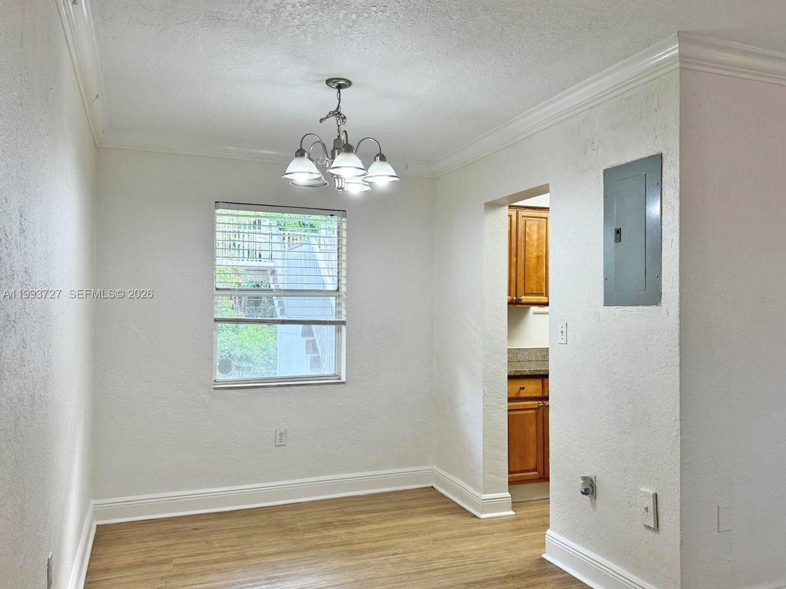 8475 Southwest 94th Street, Unit 119E Miami, FL 33156 - Photo 3 of 15 wooden floor in an empty room with a window