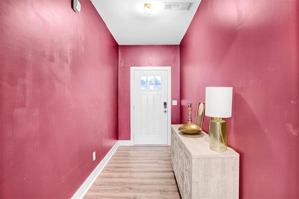 7788 Baron Road Fairburn, GA 30213 - Photo 2 of 17 a bedroom with a bed and a mirror