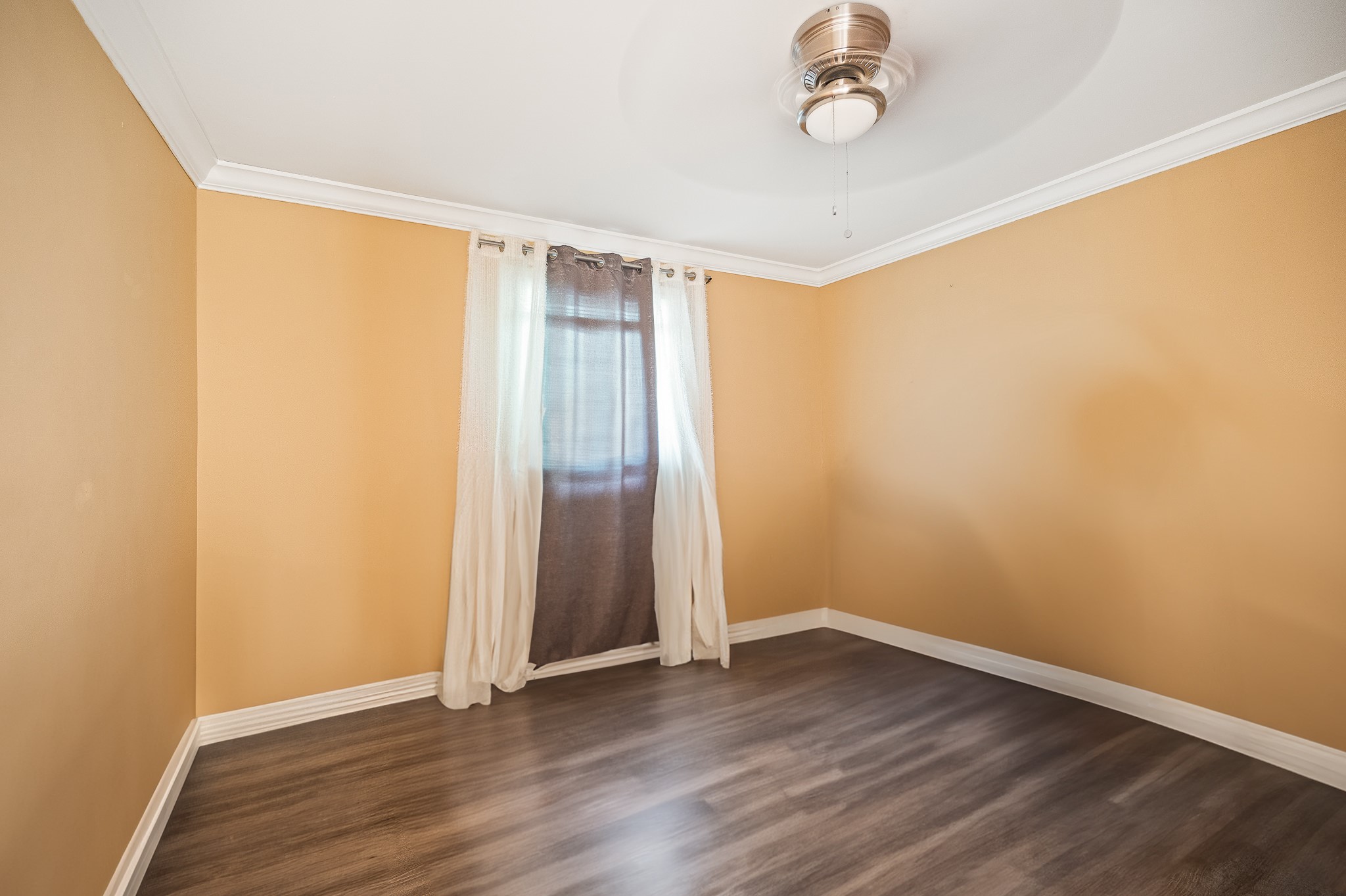 3823 Shadow Trail Houston, TX 77084 - Photo 21 of 29 an empty room with wooden floor and windows