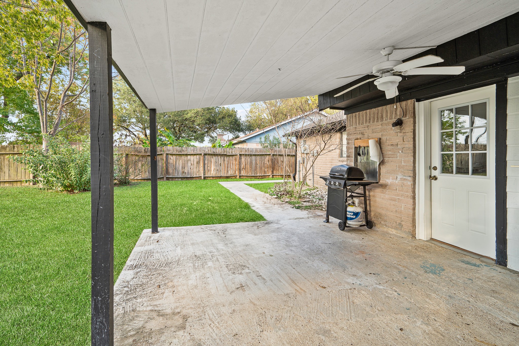 3823 Shadow Trail Houston, TX 77084 - Photo 27 of 29 a view of a backyard with couches under an umbrella